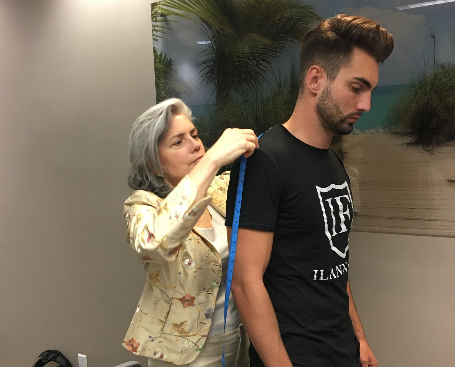 Maria measuring client for a J Hilburn customised suit